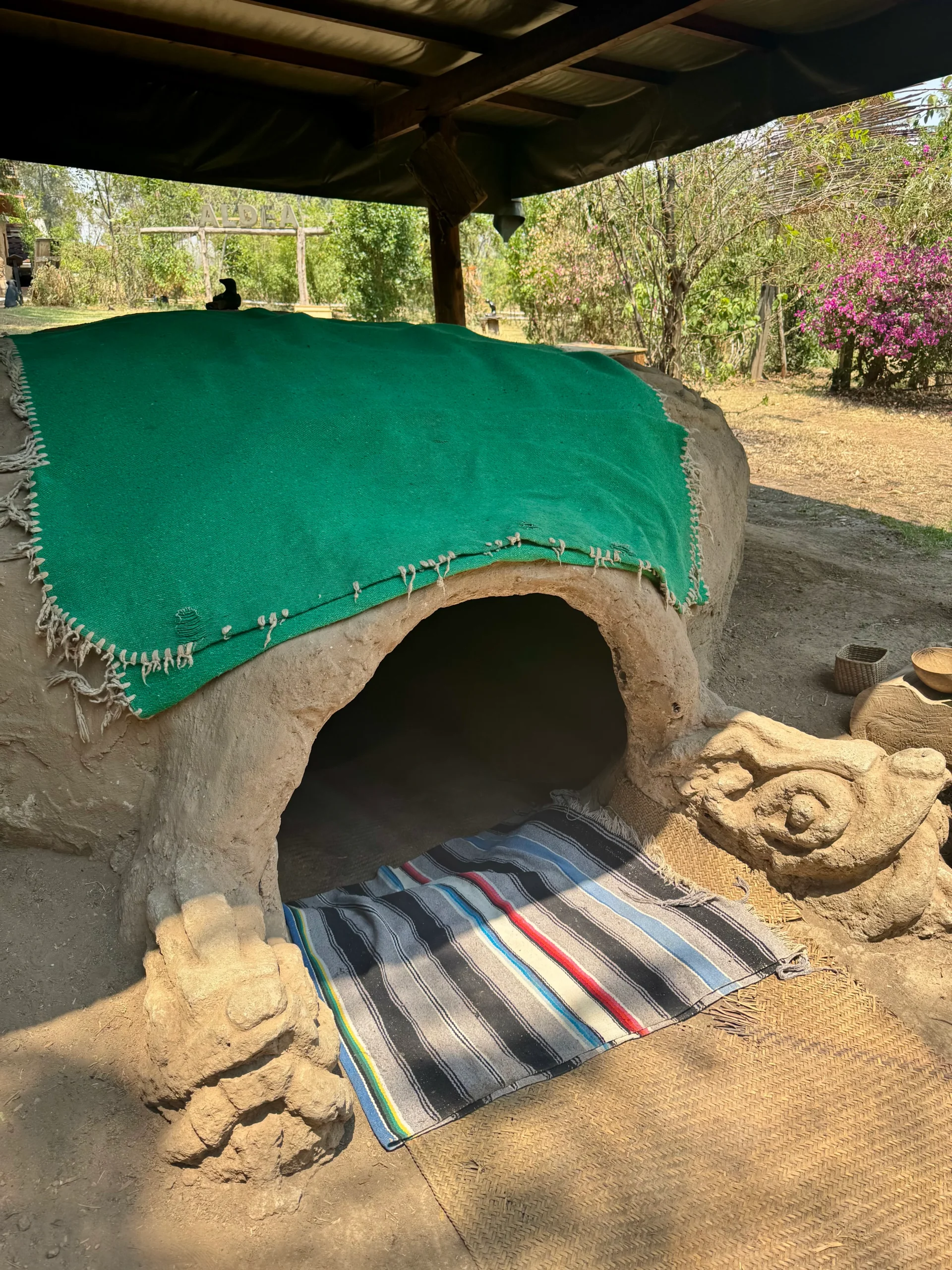 Zapotec temazcal sweat lodge entrance with colorful blanket, Mexico City. Traditional Indigenous healing ceremony, spiritual purification, ancient wisdom.
